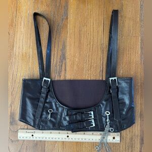 Brown pleather harness with silver key and chain accents.